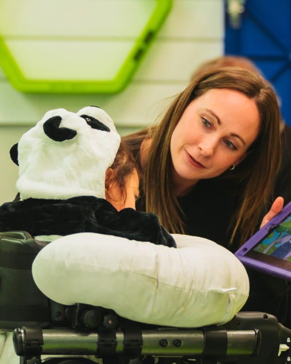 A physiotherapist at Montreal KPG working with a child using the Trexo Exoskeleton Device